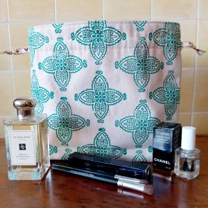 Handmade block-printed drawstring bag front with products