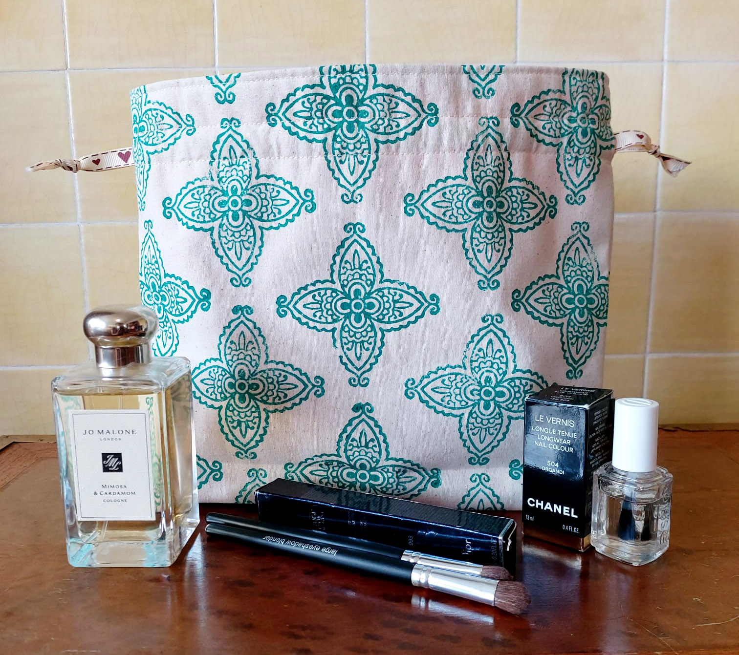 Handmade block-printed drawstring bag front with products